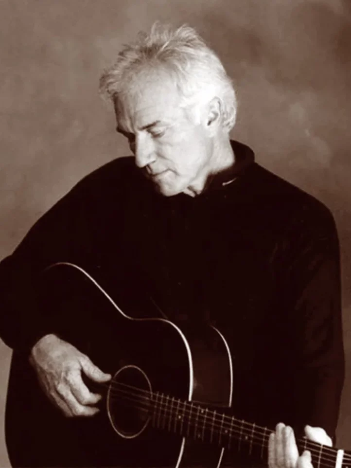 Paul Clark portrait playing a guitar